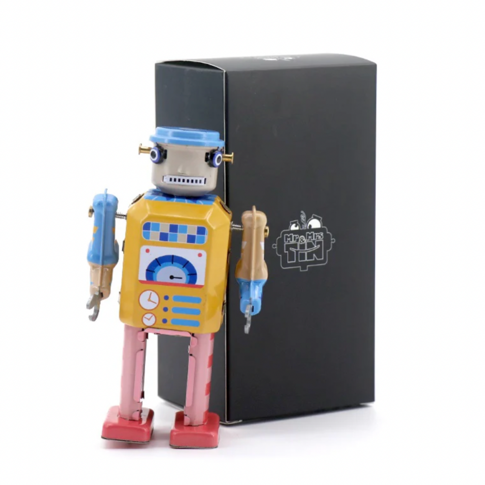 Colorful toy robot next to a black box on a white background