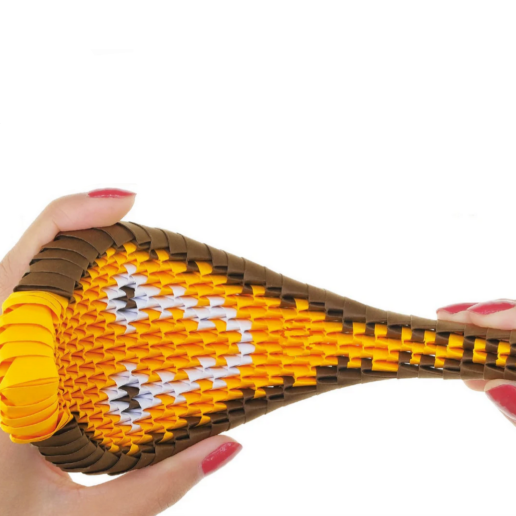 Hand holding a toy snake with a detailed pattern