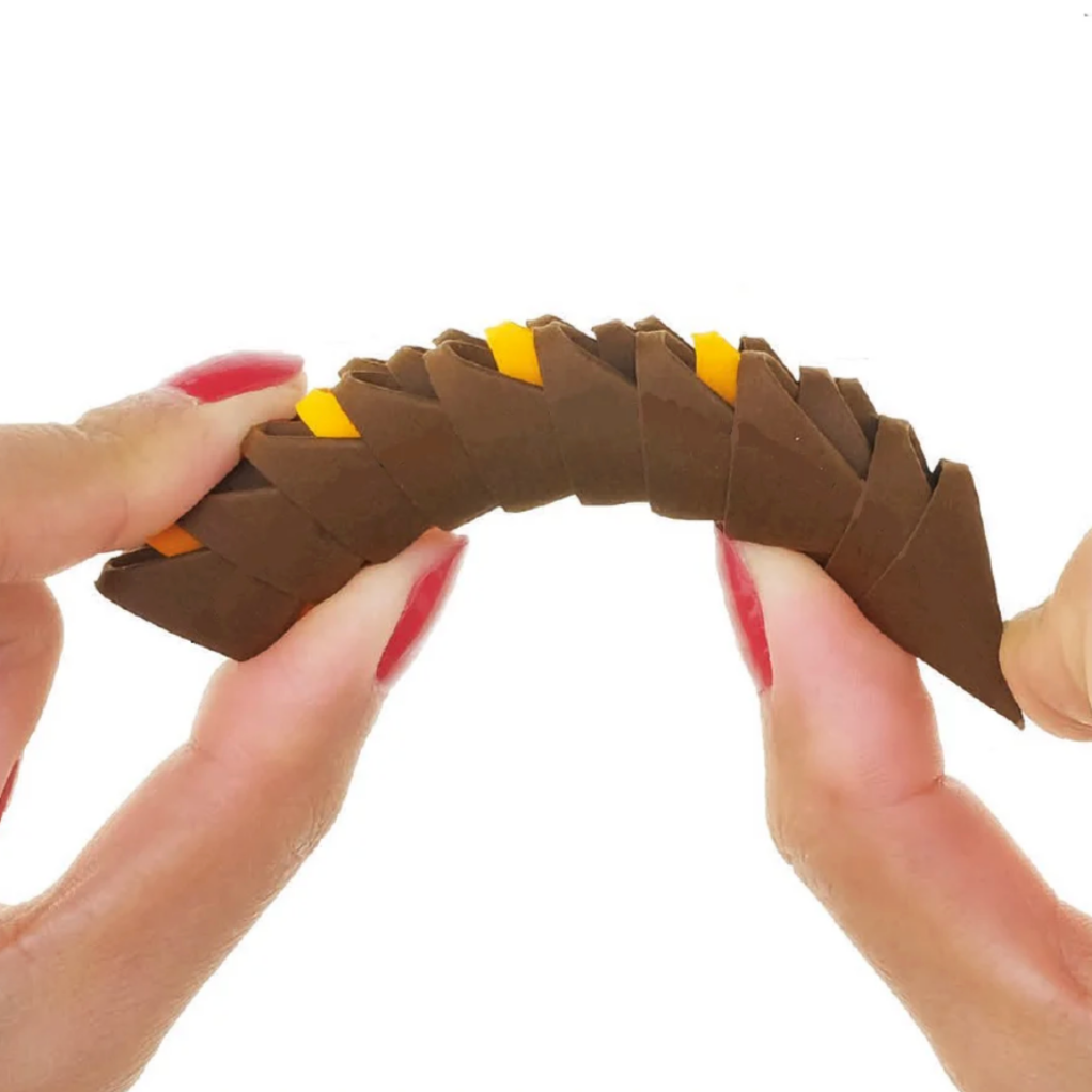 Hands holding a flexible snake-shaped object with small yellow accents on a white background.