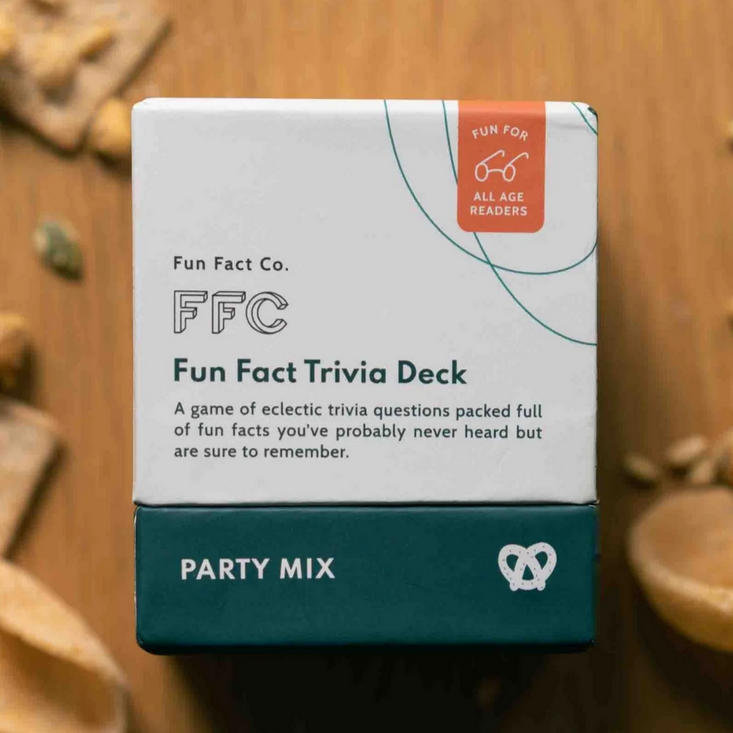 Fun Fact Trivia Deck packaging on a wooden surface with snacks.