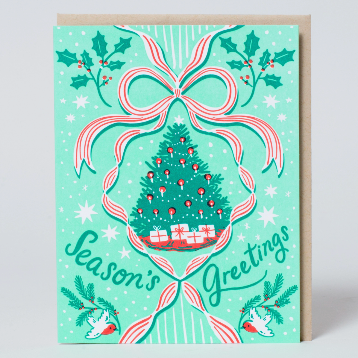 Christmas-themed greeting card with a tree, presents, and bow on a light blue background.
