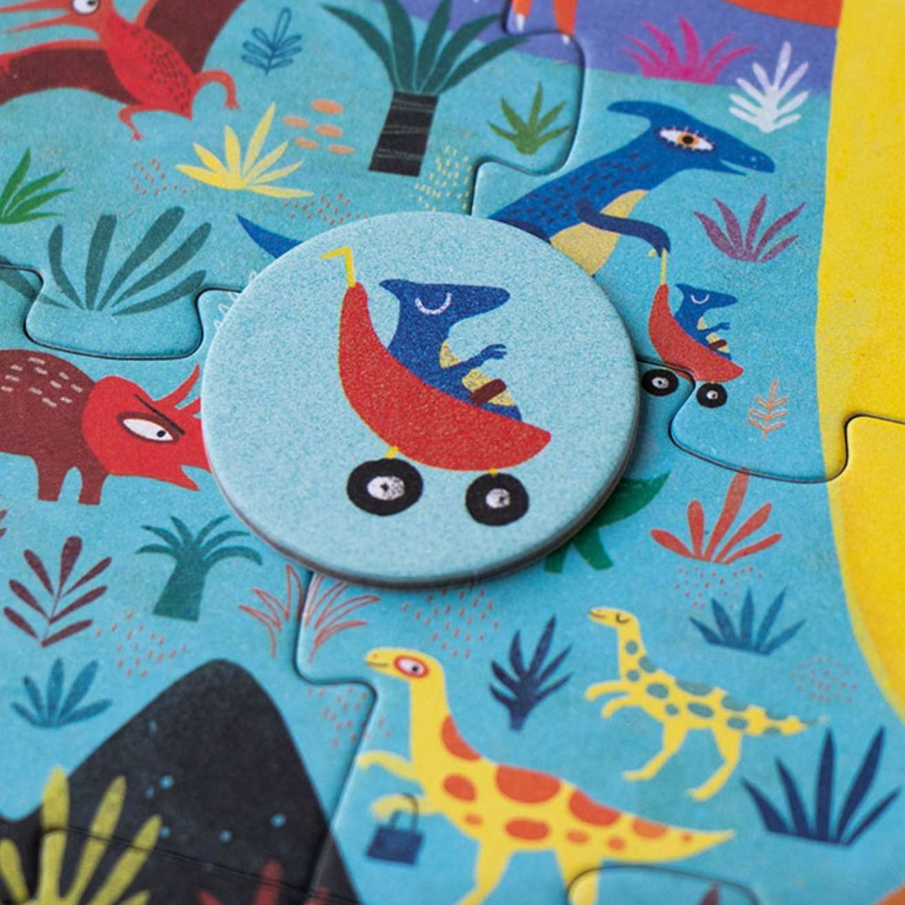 Children's puzzle with colorful dinosaur illustrations on a blue background