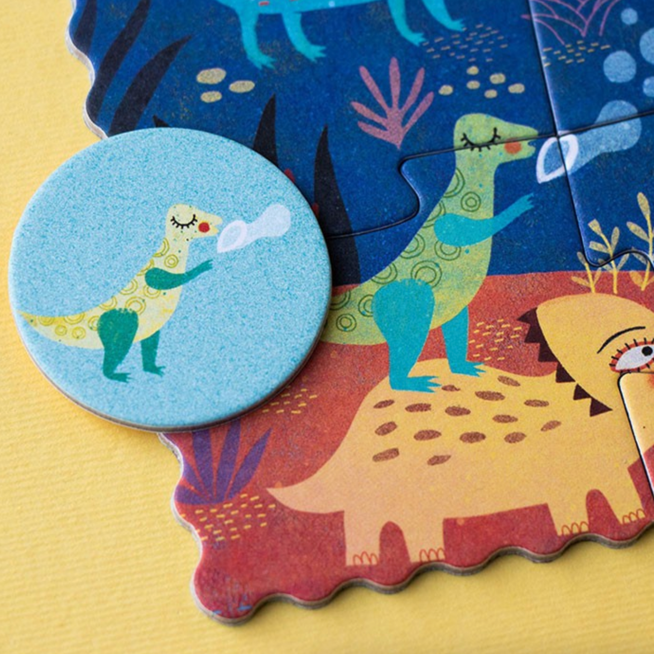 Children's dinosaur puzzle with a focus on a round piece featuring a cartoon dinosaur blowing bubbles.