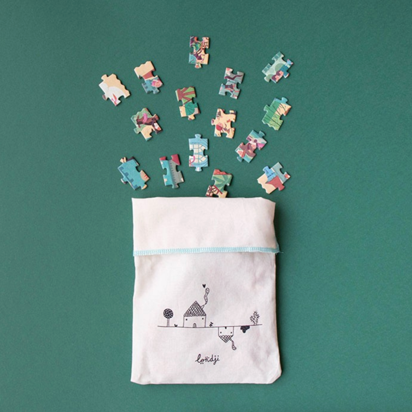 Puzzle pieces spilling out of a white drawstring bag with a design on a green background