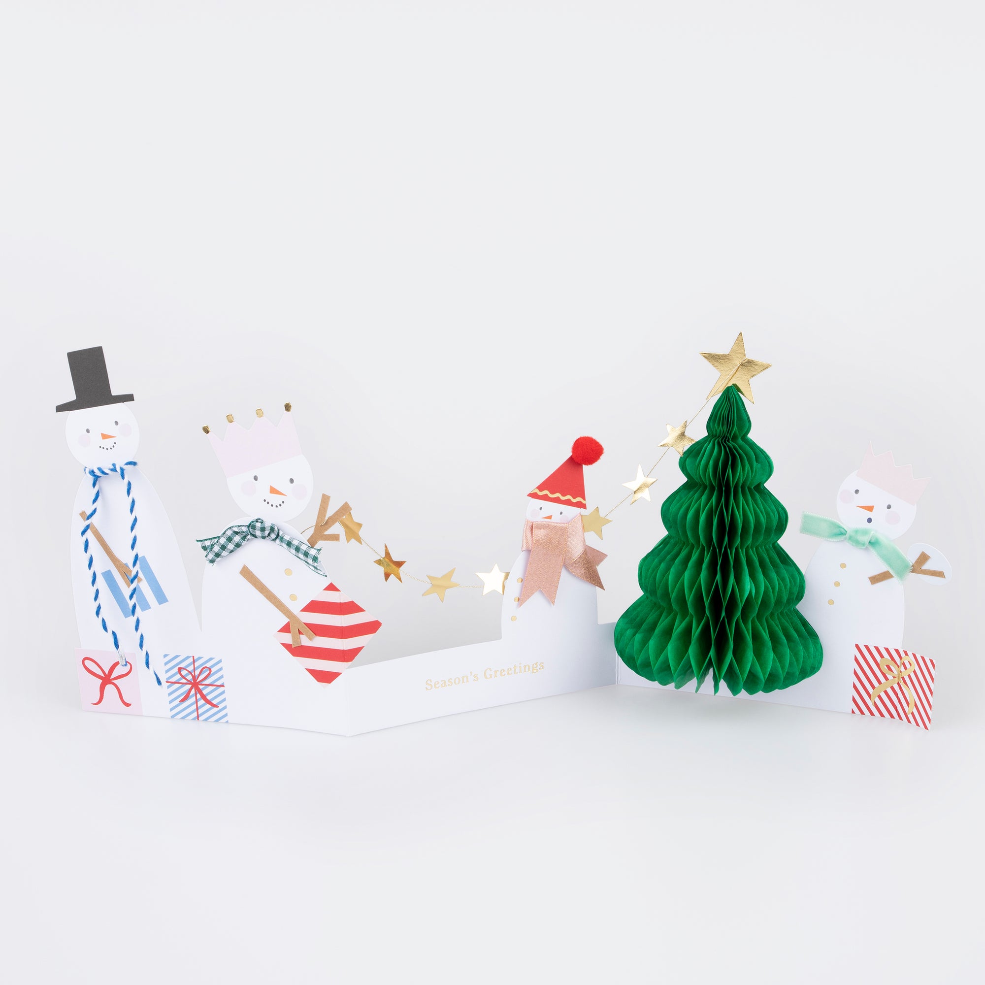 A Christmas card with a design featuring four snowmen and a Christmas tree adorned with embellishments.
