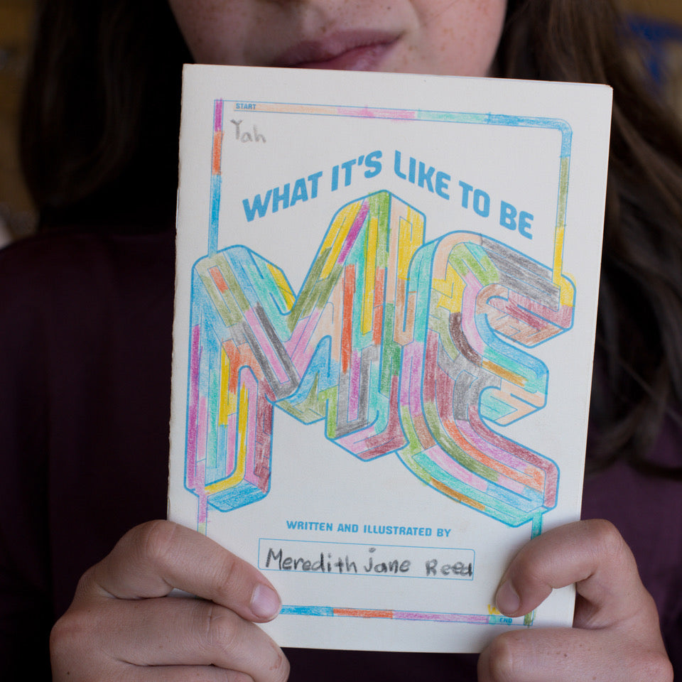 Book titled 'What It's Like to Be Me' held by a person