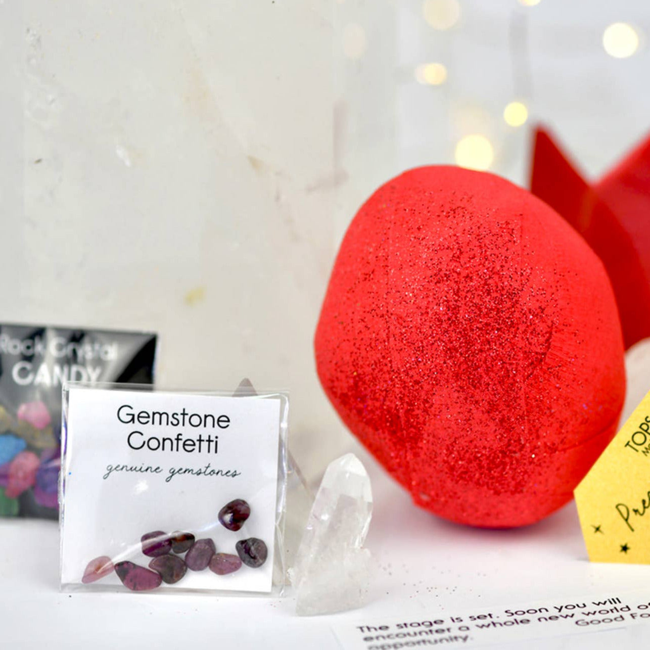 Red surprise ball with packaging and accessories on a white surface