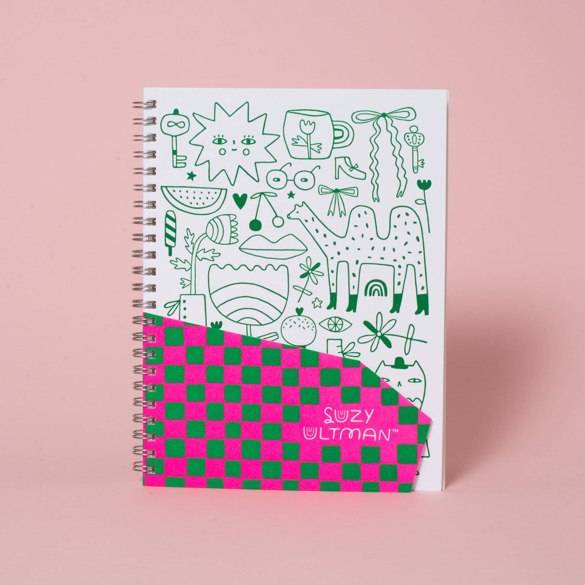 Notebook with colorful design on a pink background