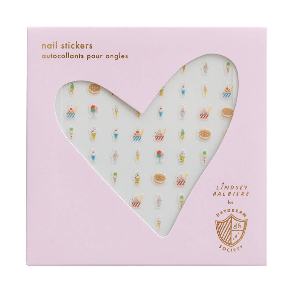 Heart-shaped nail sticker sheet with miniature illustrations on a pink background, featuring the Lindsey Balbère brand.