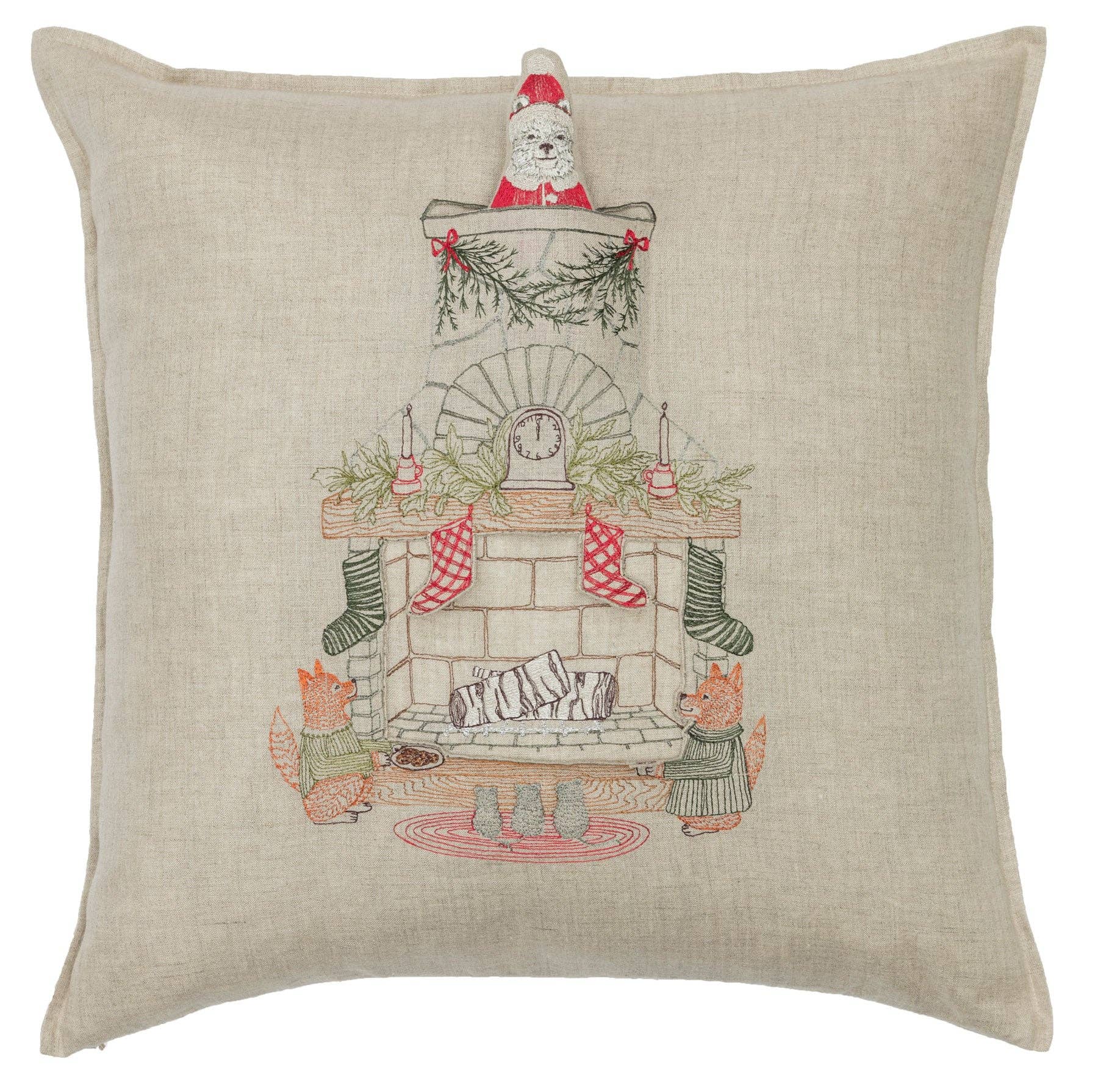 Decorative pillow with a Christmas scene featuring a tree, stockings, and a fireplace.