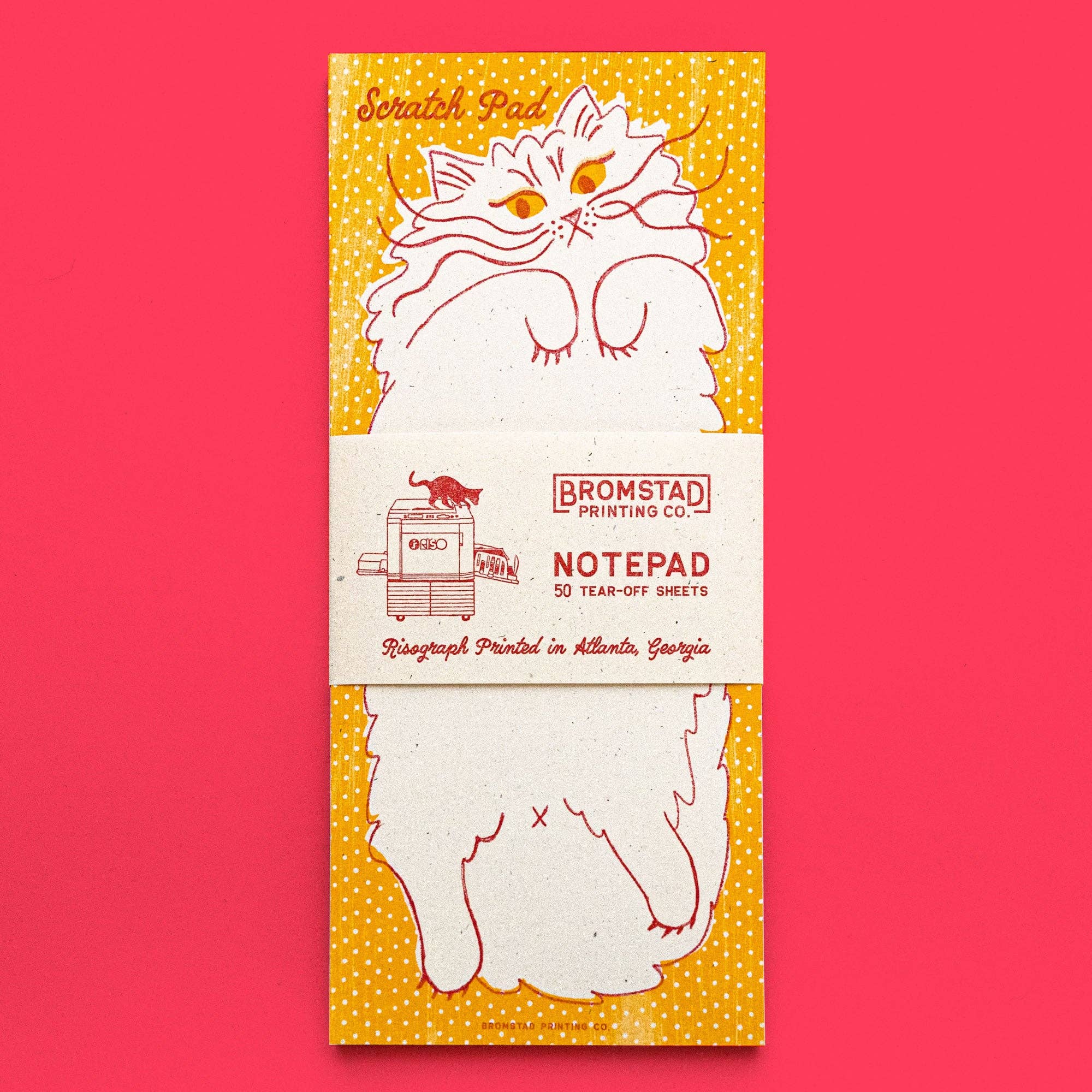 Notepad with cat illustration on a red background