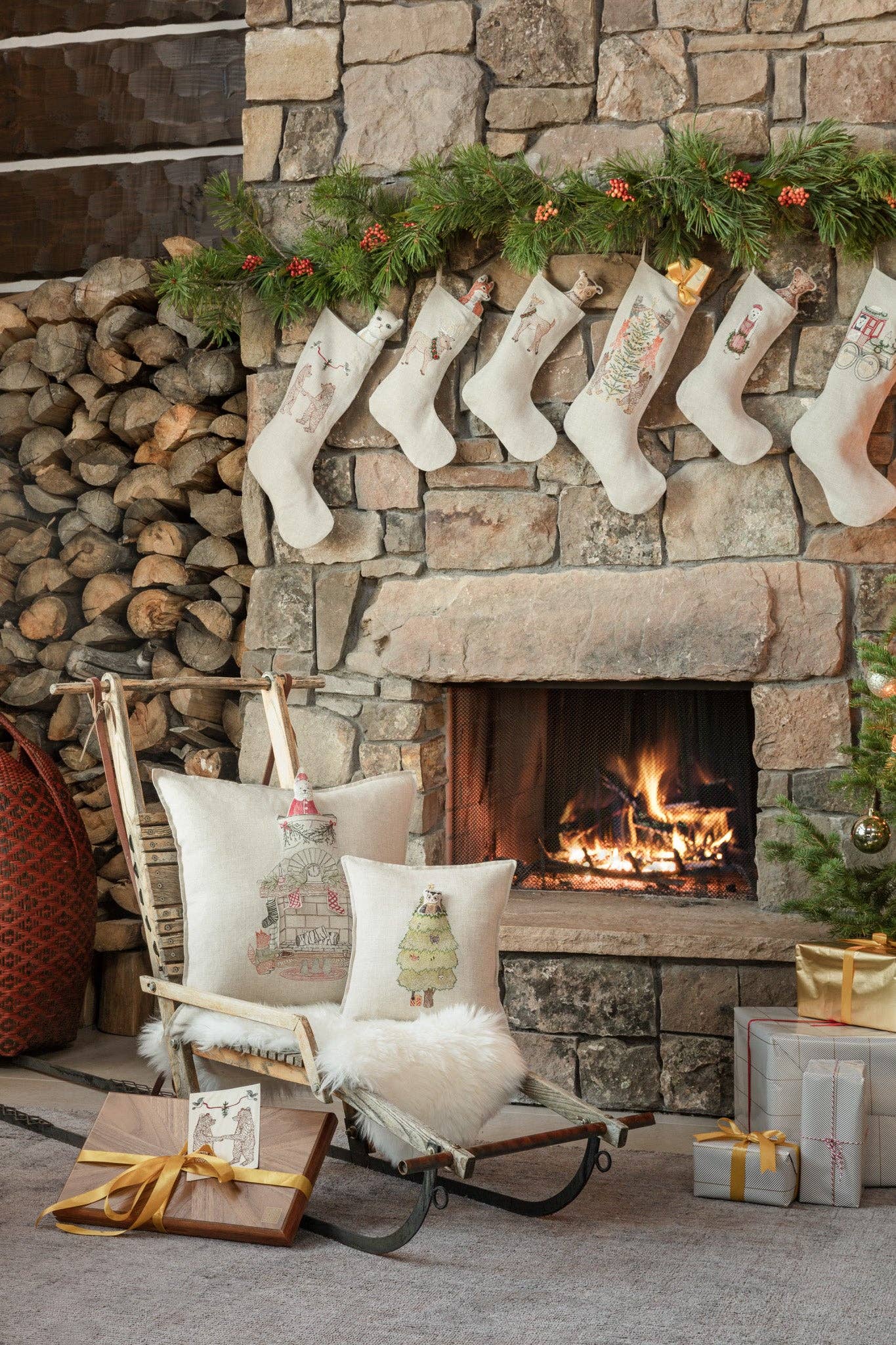 Cozy living room with stone fireplace, stockings, and festive decor.