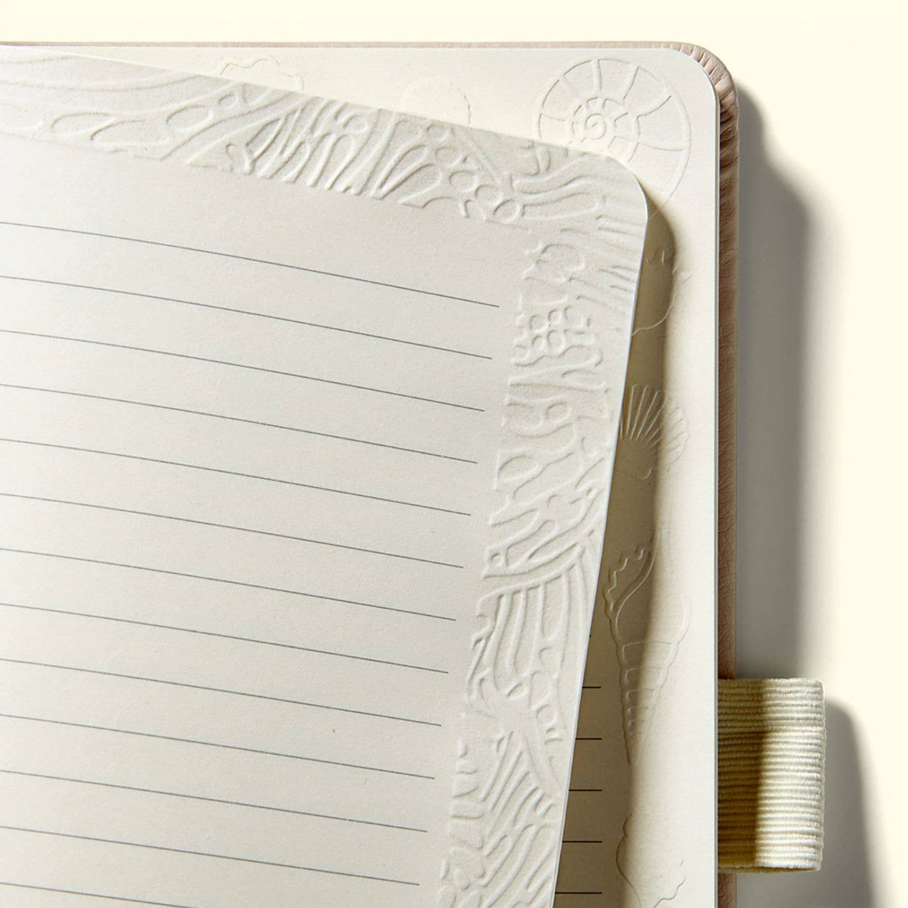 Notebook with textured surface and lined pages on a white background