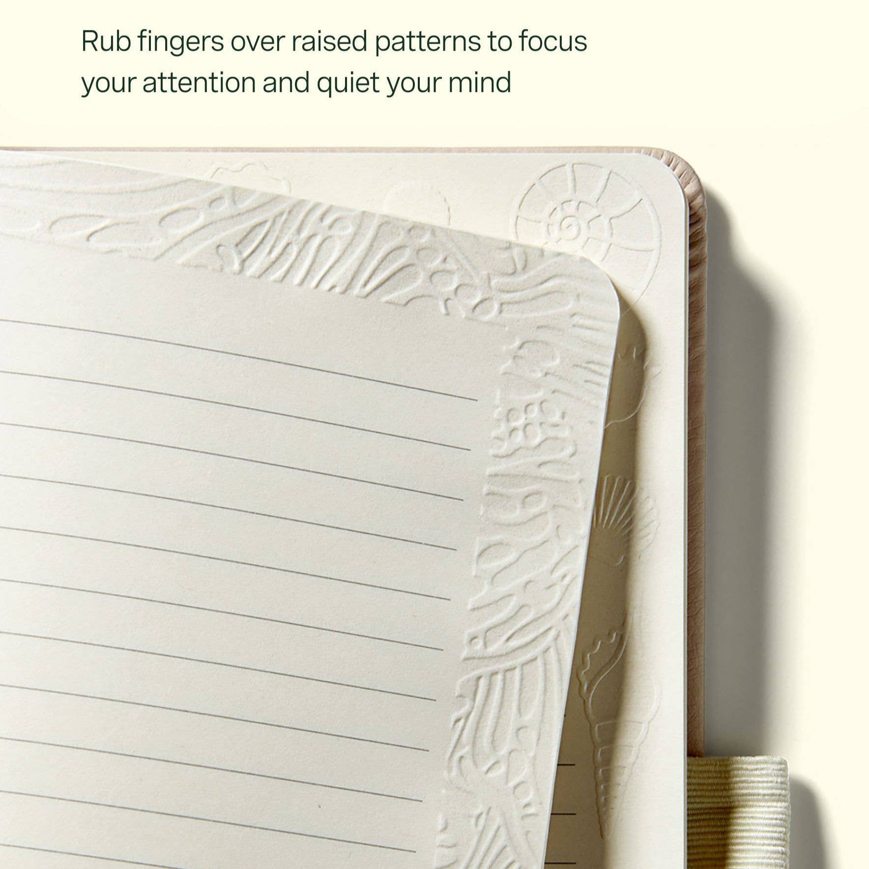 Notebook with textured surface and lined pages on a white background