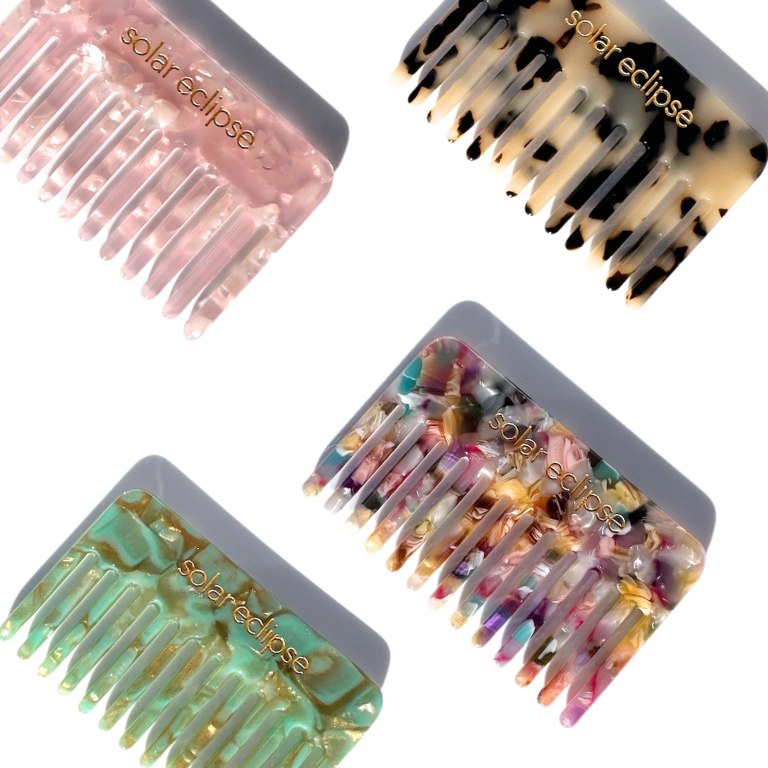 Four hair combs with 'solar eclipse' branding on a white background