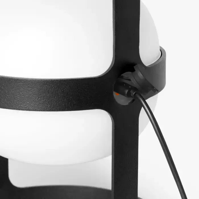 Close-up of a modern lamp with black and white design on a white background