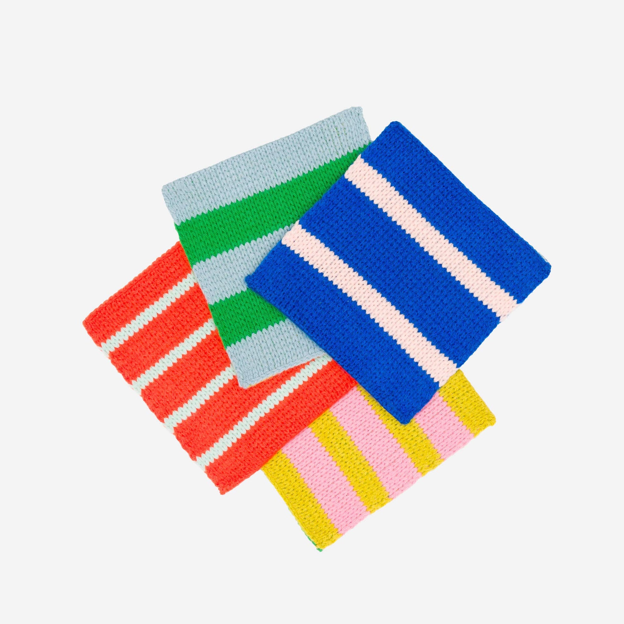 Set of colorful striped knitted coasters on a white background