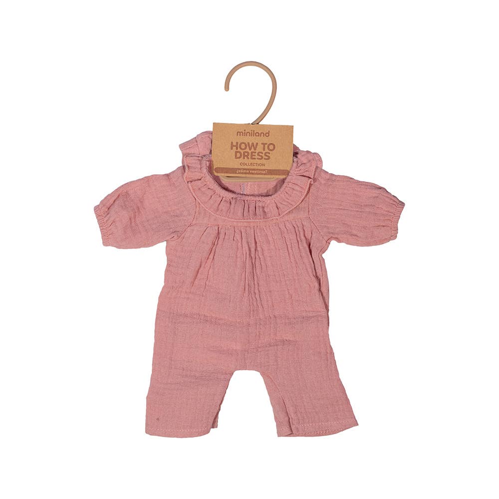 Pink doll outfit with ruffled top and pants on a hanger against a white background