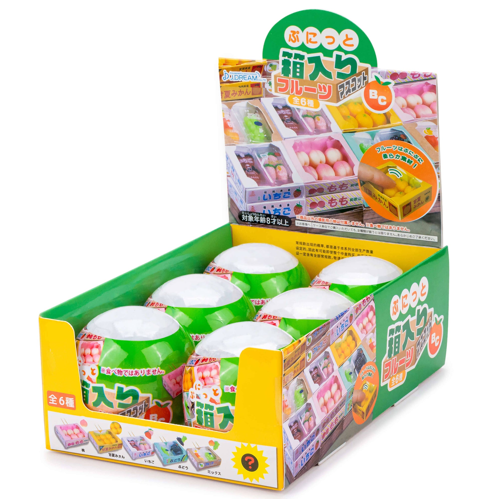 Display box with green containers and colorful packaging on a white background