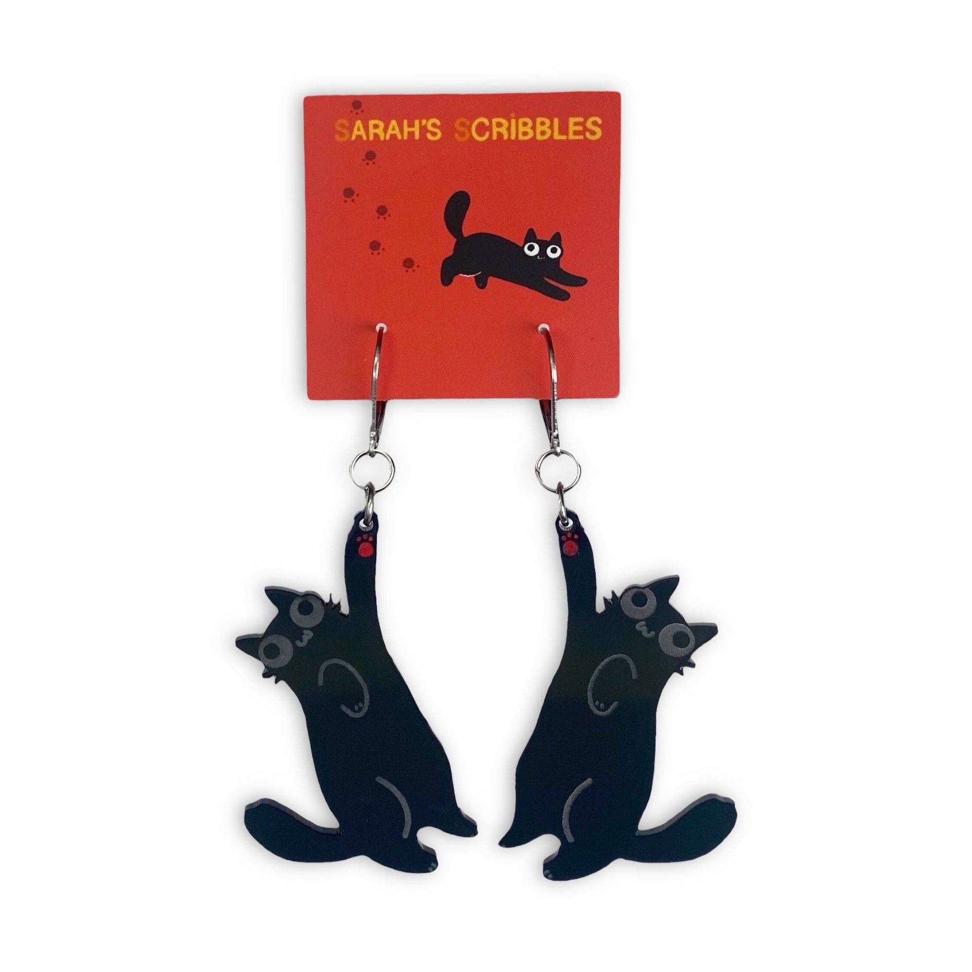 Black cat-shaped earrings on a 'Sarah's Scribbles' branded card.