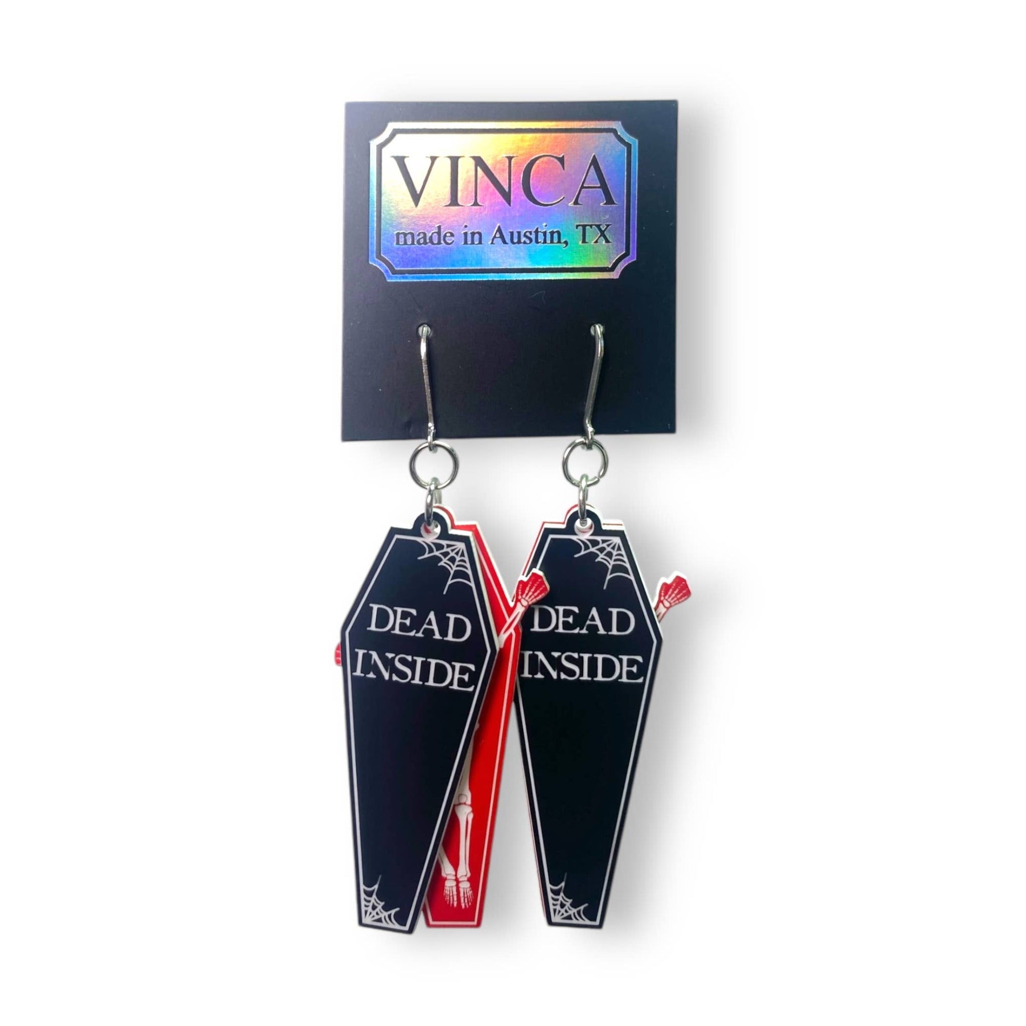 Coffin-shaped earrings with 'Dead Inside' text on a Vinca branded card.