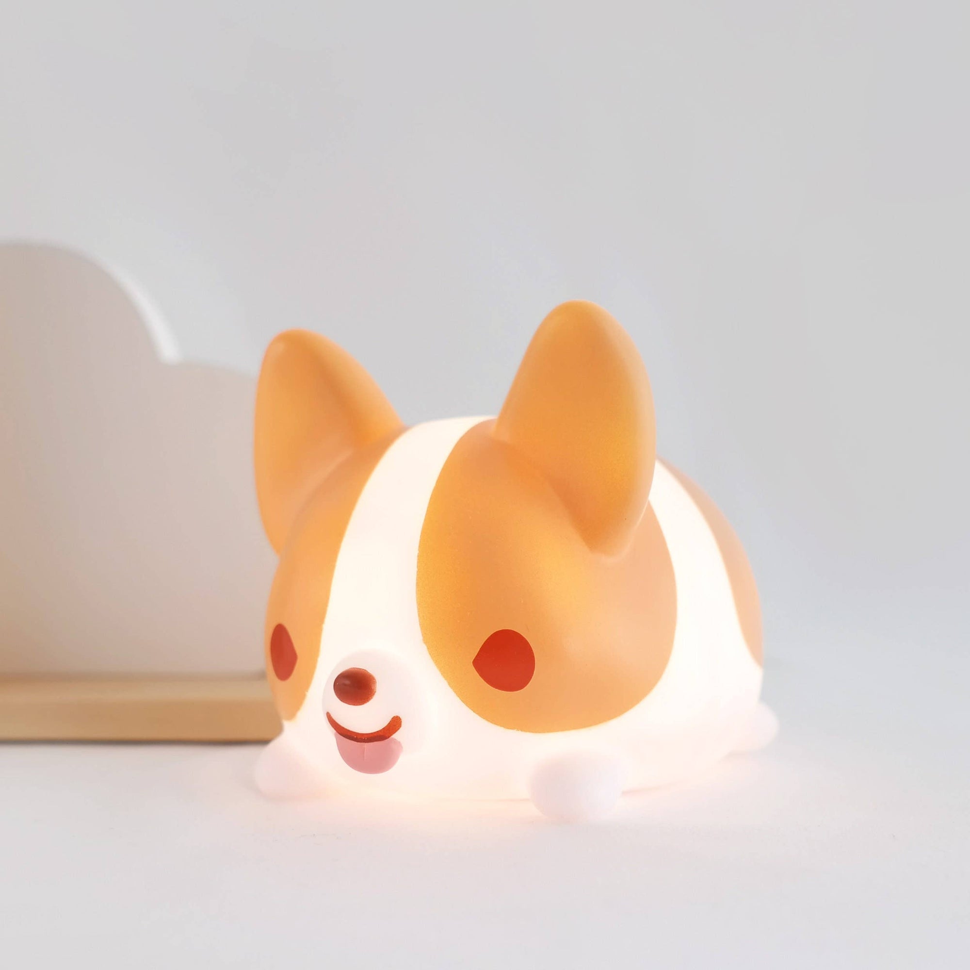 Corgi-shaped night light on a white surface with a light gray background
