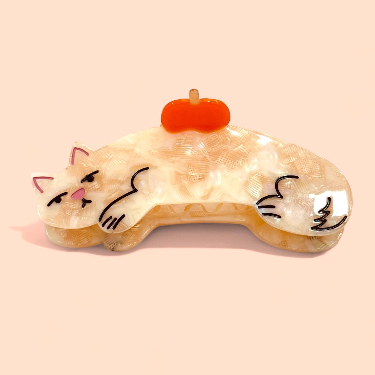 Cat-shaped hair claw with an apple on a the cat's back