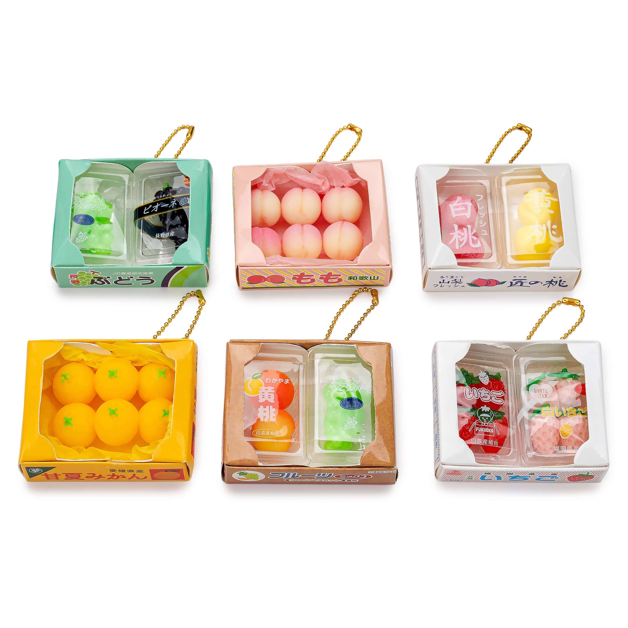 Set of toy small fruit-shaped containers in various packaging designs on a white background