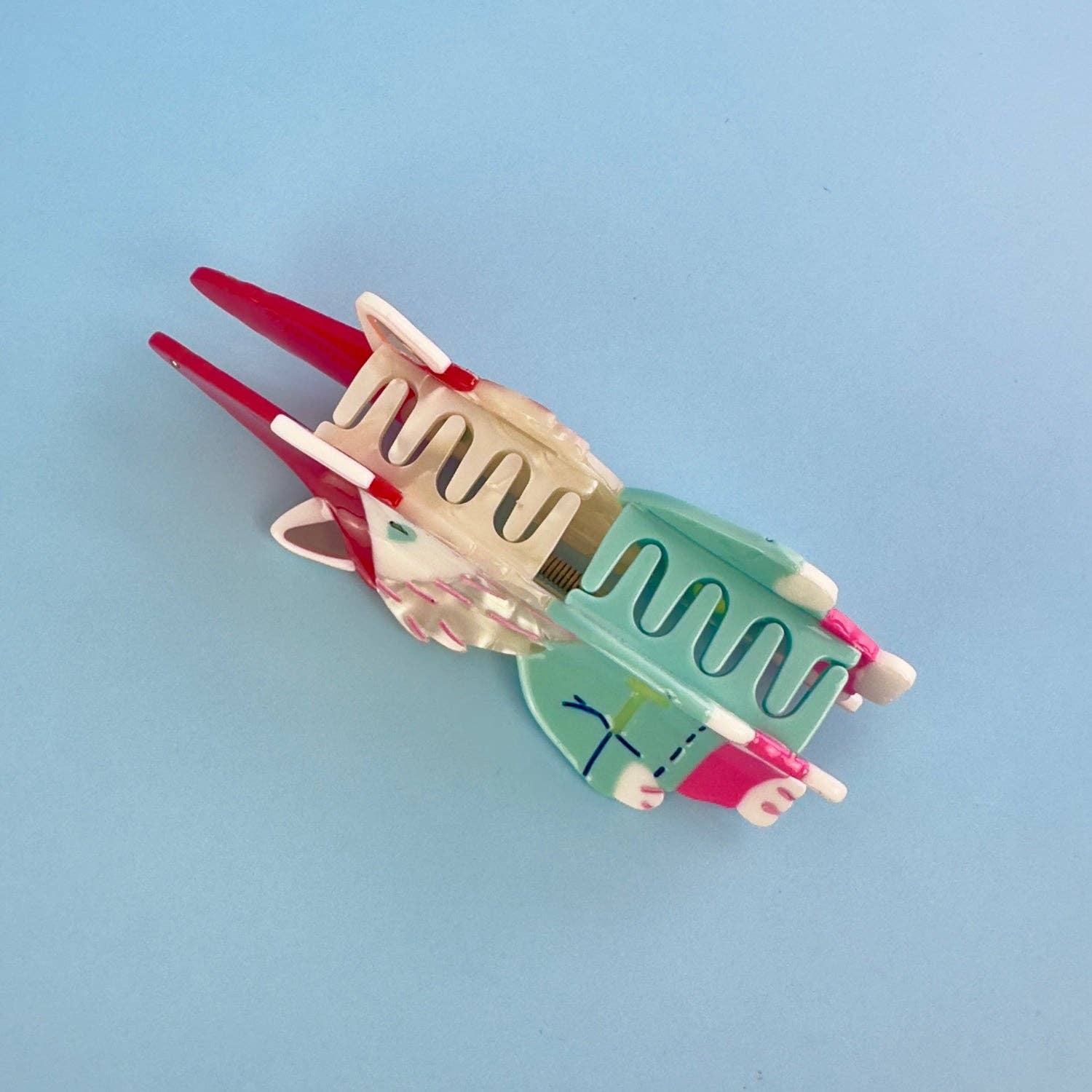 Colorful hair clip on a light blue background