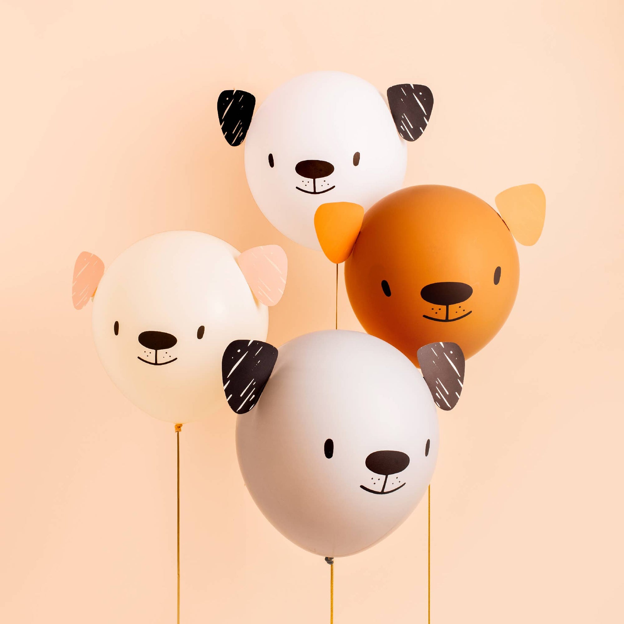 Four animal-shaped balloons with faces on a peach background