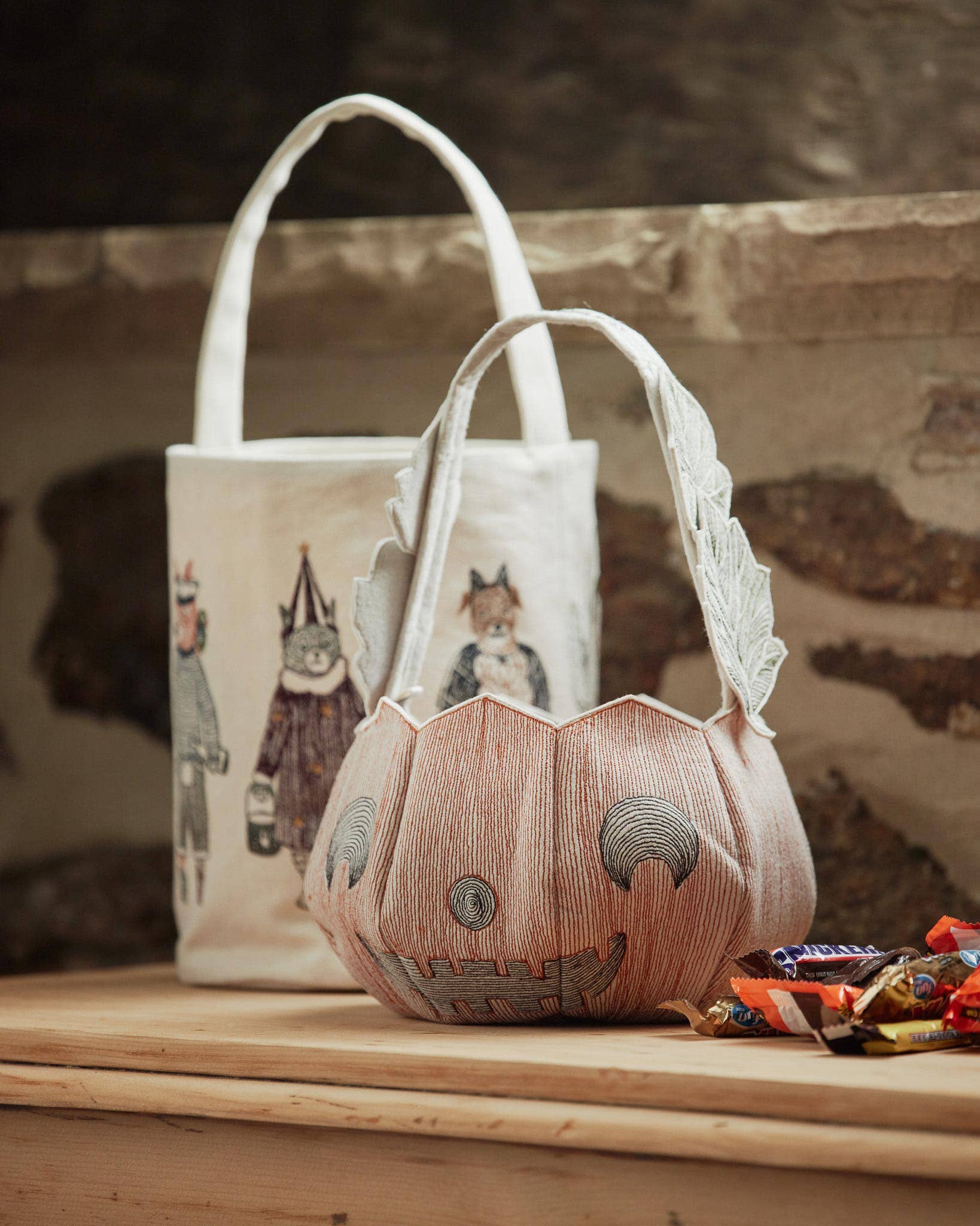 Decorative bags with printed designs on a wooden surface