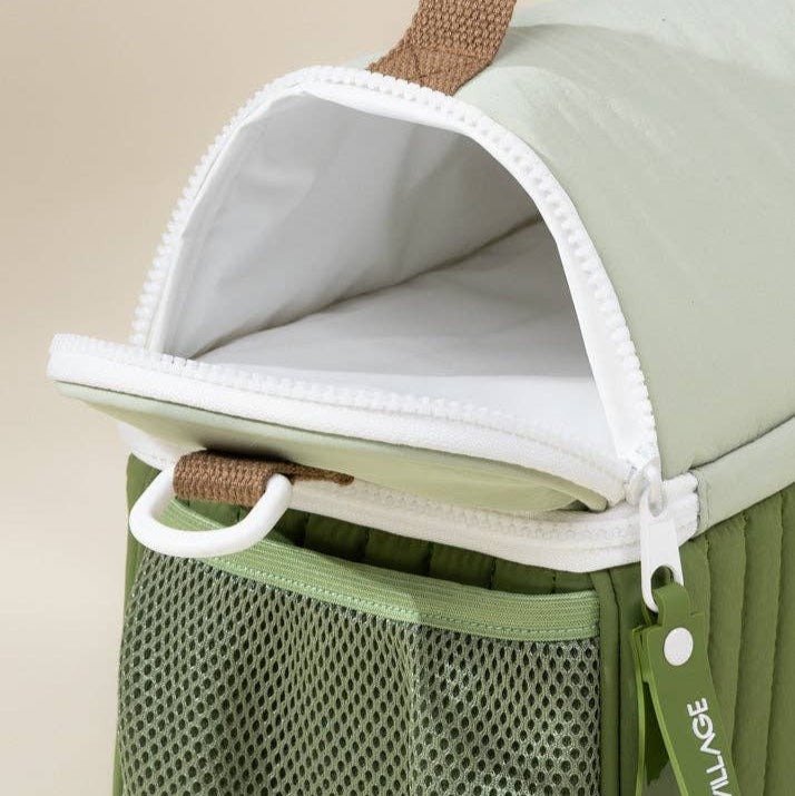 Green lunhbox bag with a mesh pocket on a beige background