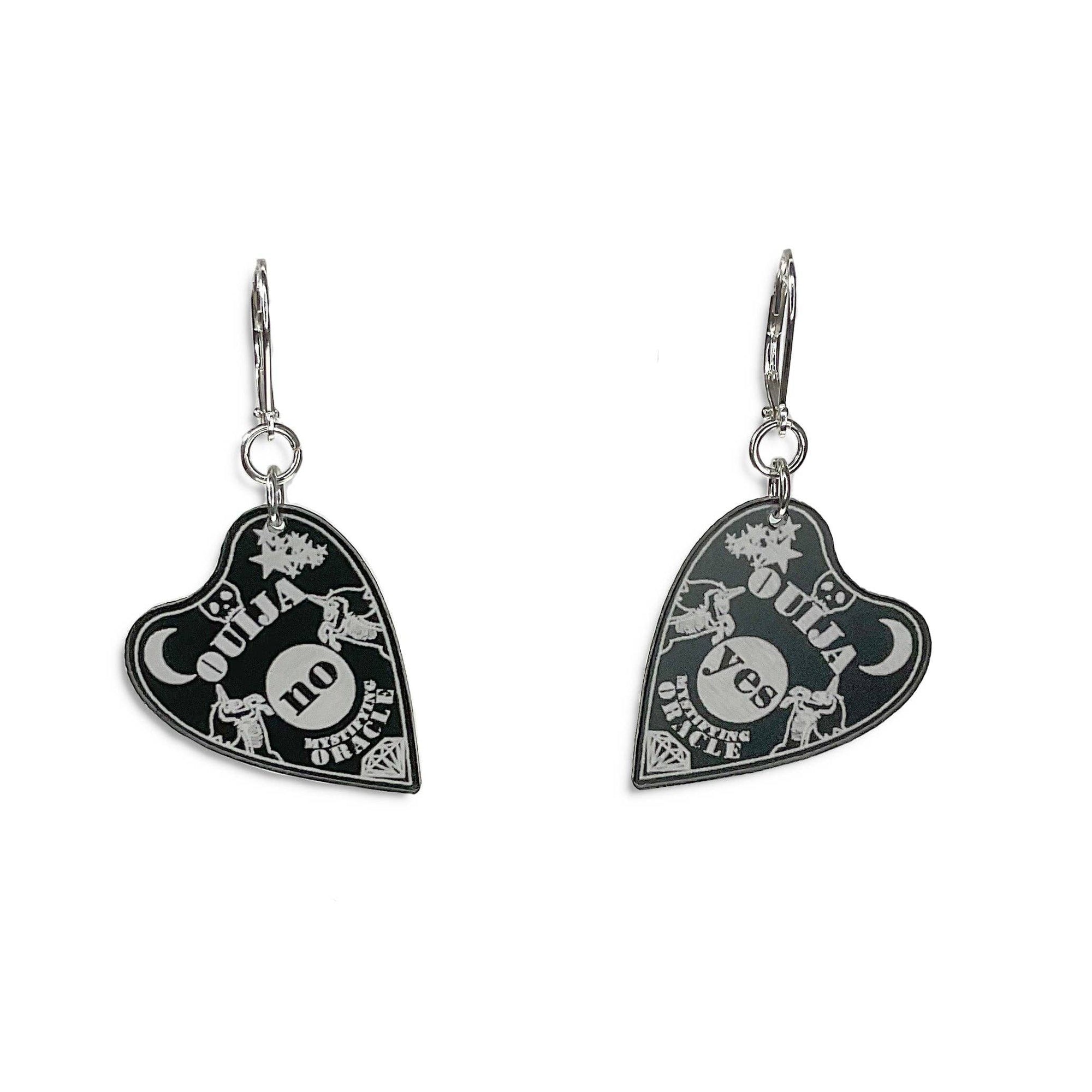 Heart-shaped Ouija board earrings on a white background