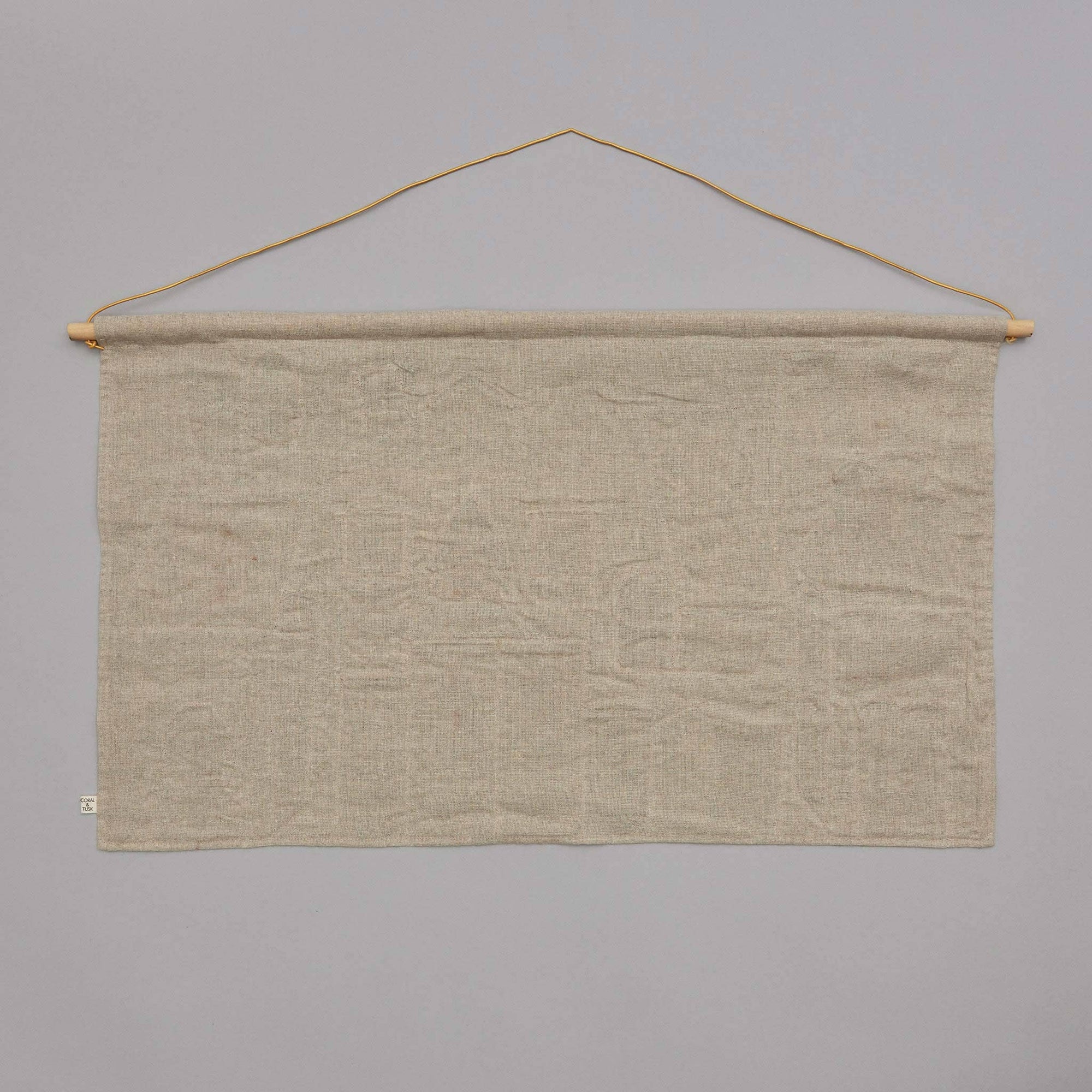 Beige fabric banner hanging on a gray wall