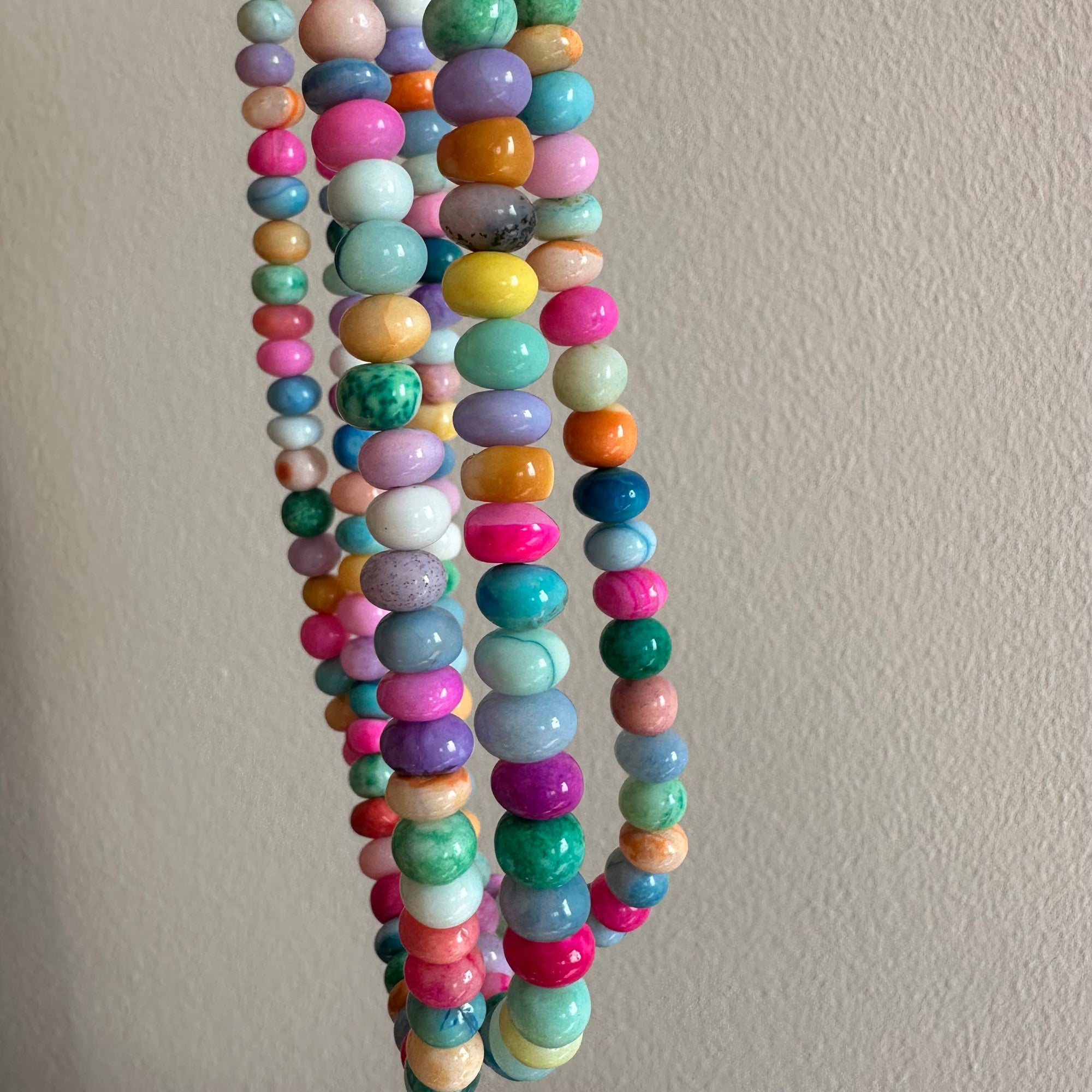 Colorful beaded necklace on a plain background