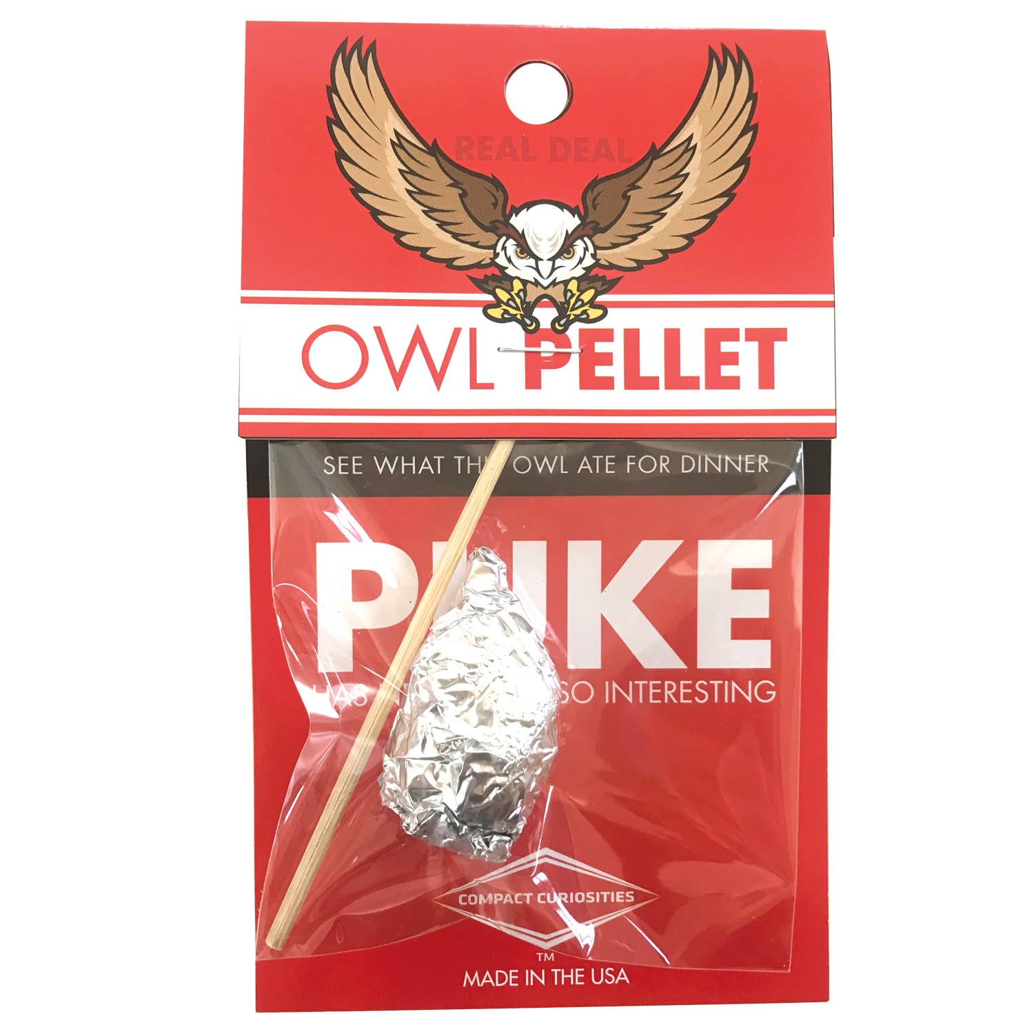 An owl pellet science kit packaged in a red and clear plastic bag with a label that includes text and the brand logo featuring an owl and wings.
