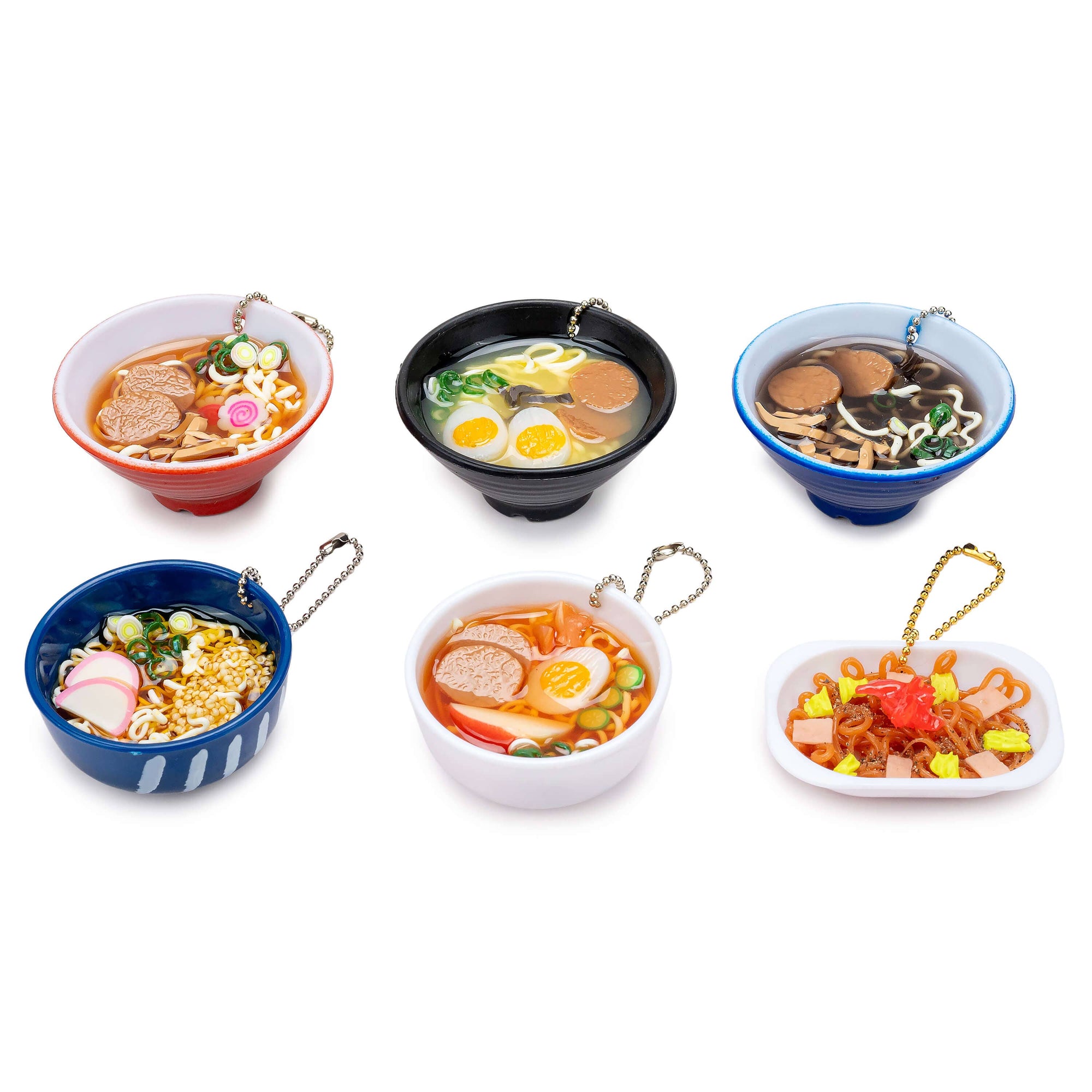 Set of miniature toy ramen bowls with different toppings on a white background