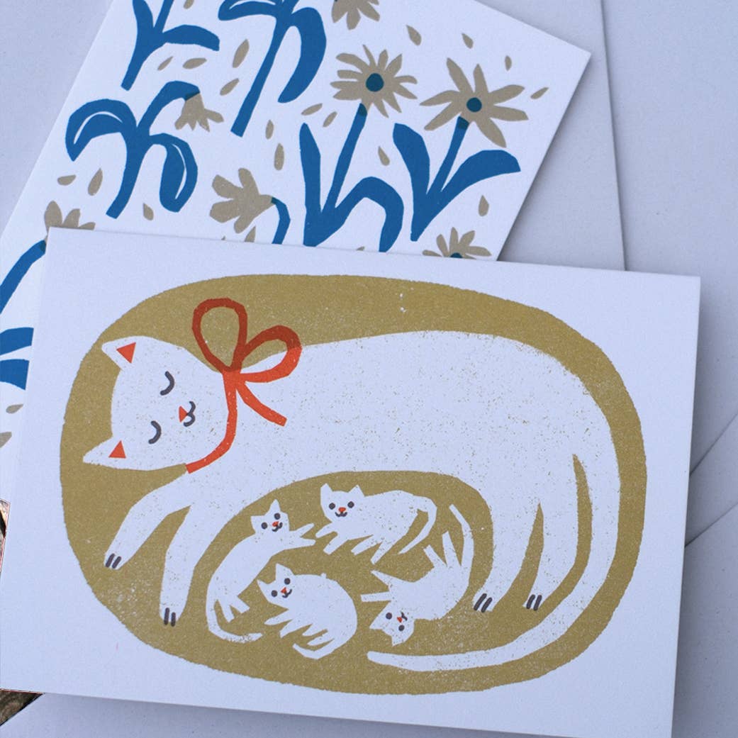 Greeting card with a cat and kitten design on a white background