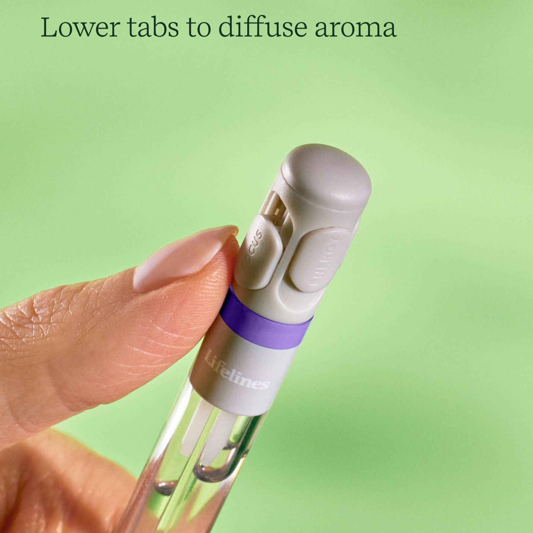 Hand holding a pen with a purple band, labeled 'Lifeline', against a green background.