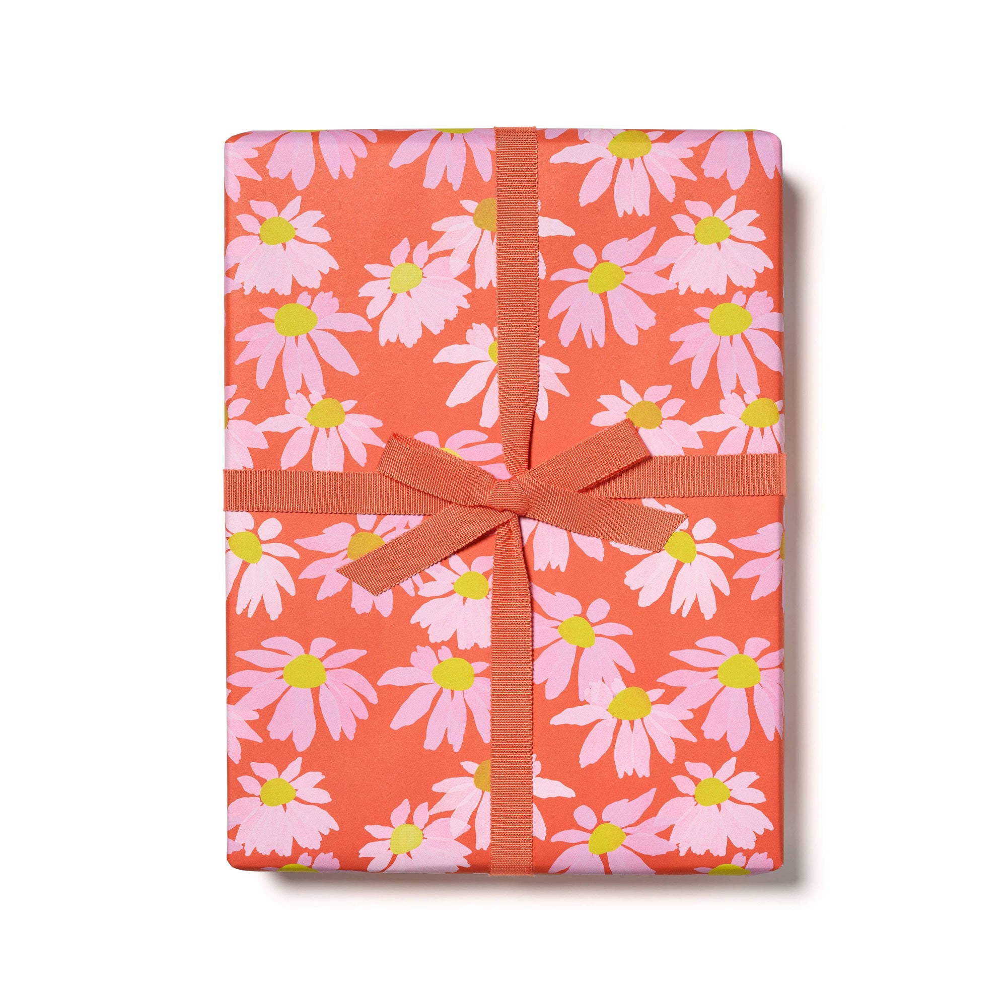 Gift box with pink floral pattern and orange ribbon on a white background