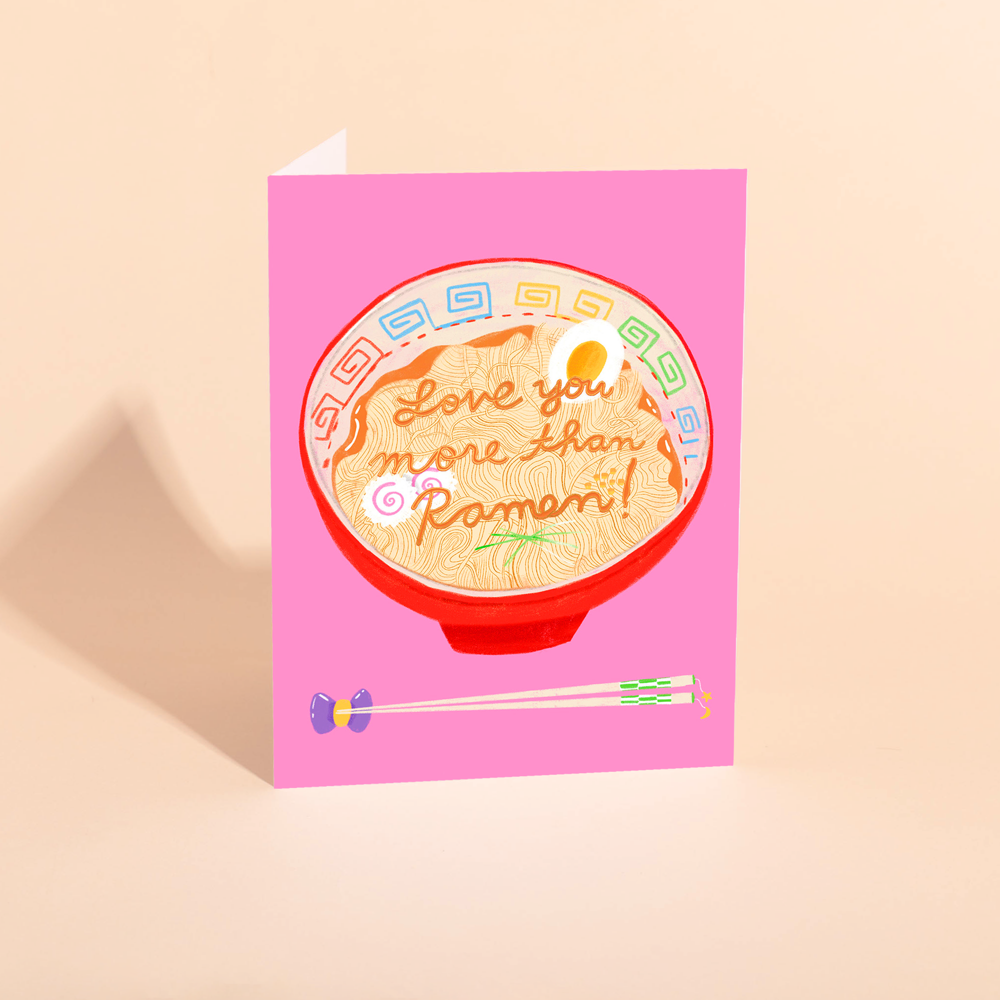 Greeting card with ramen illustration and text on a pink background
