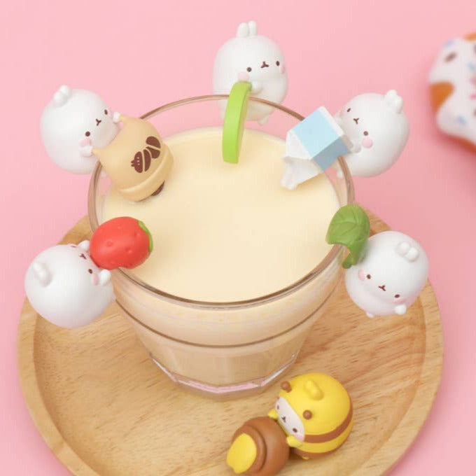 Glass of milk with cute animal-shaped marshmallows on a pink background