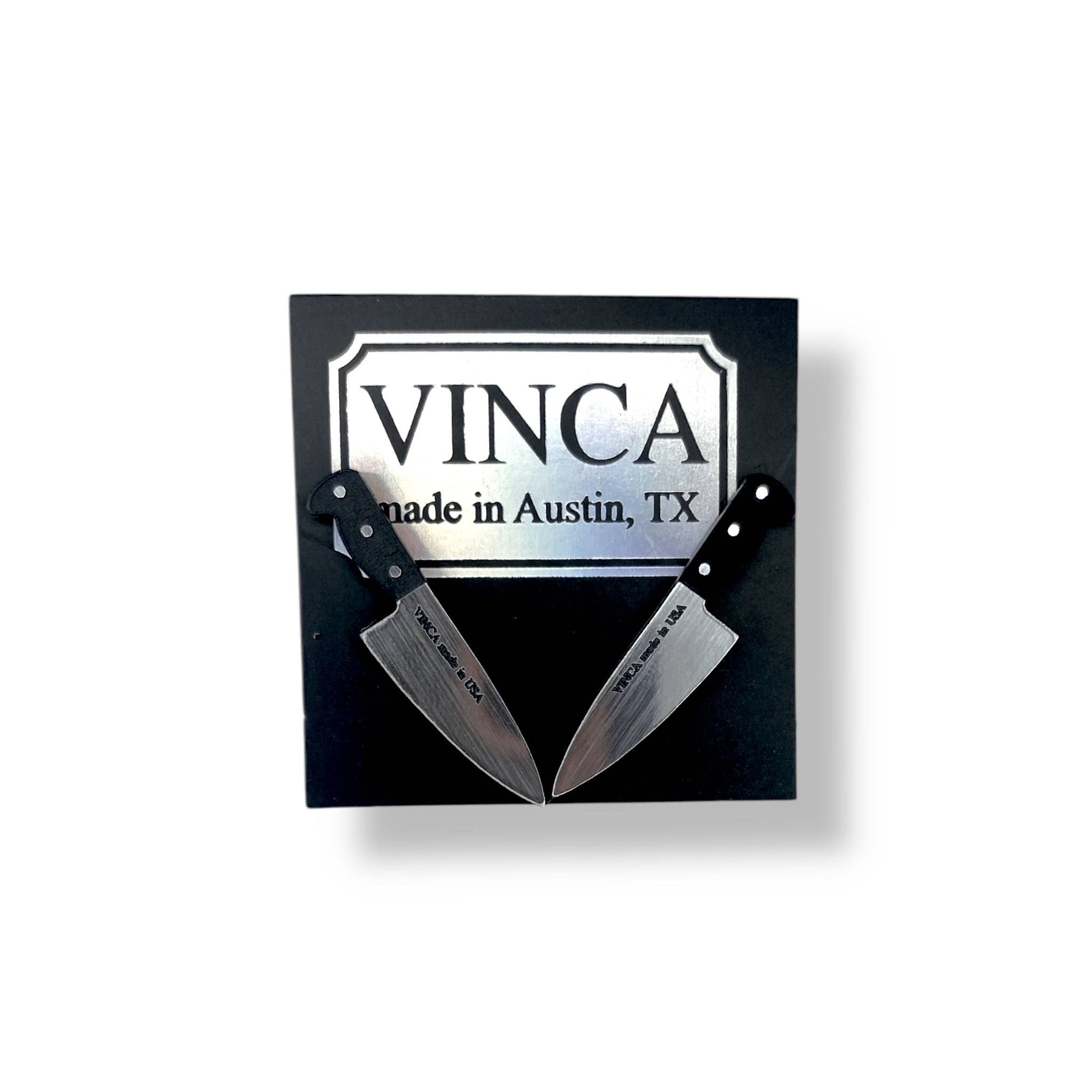 Two knives with a 'VINCA' logo and text on a black background