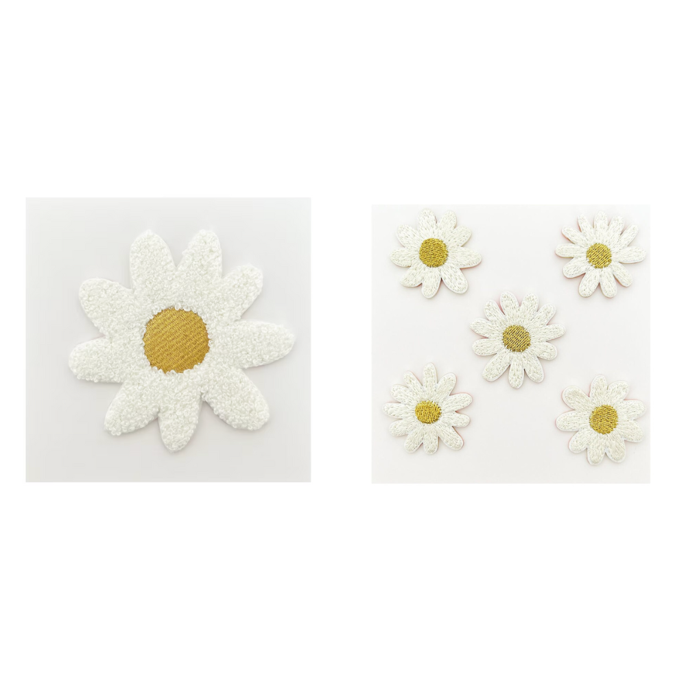 Set of white daisy flower patches with yellow centers on a white background