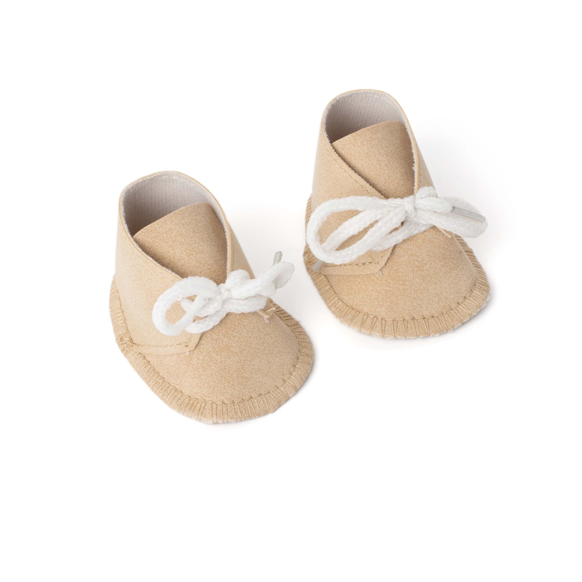 Pair of beige doll shoes with white laces on a white background