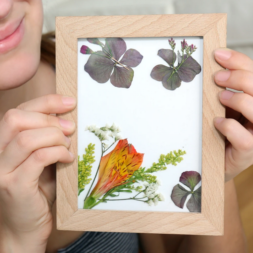 person holding art frame