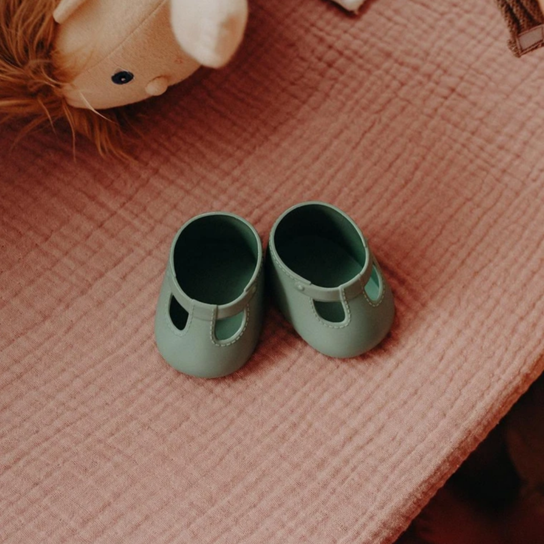 green shoes on pink bed
