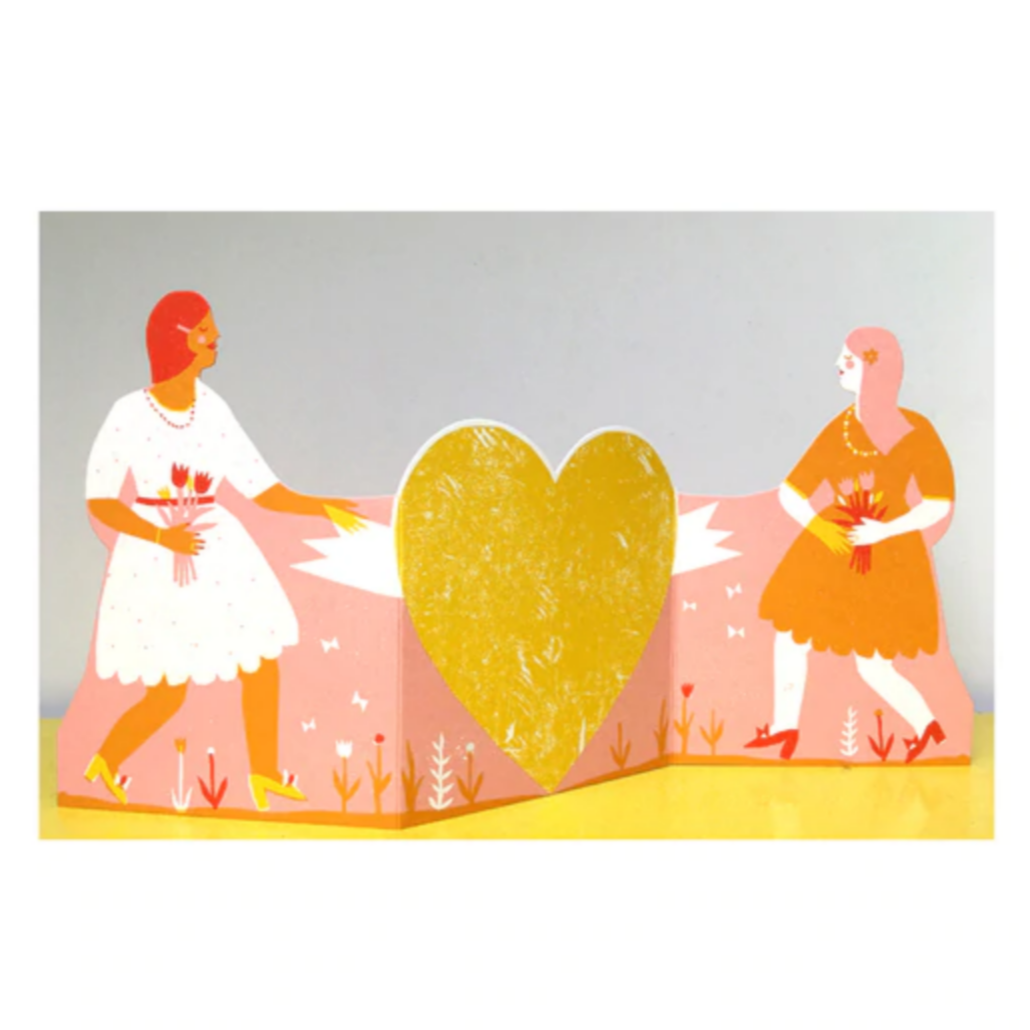 two women with heart between them when card is opened up
