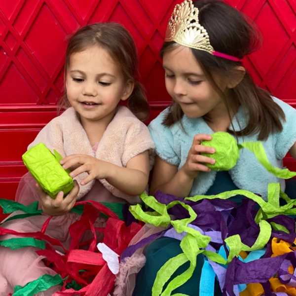 two little girls unwinding surprize balls and gift