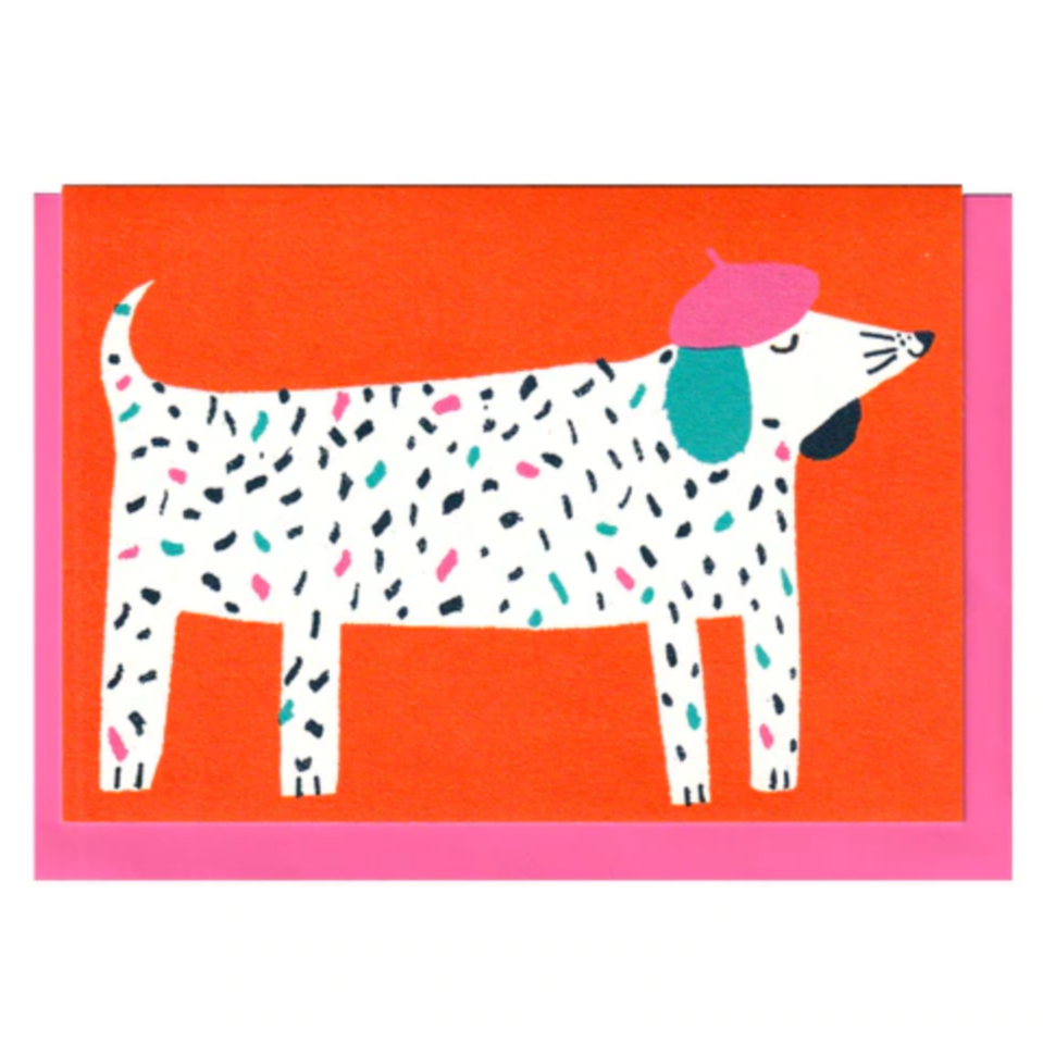 A colorful greeting card featuring a patterned dog wearing a hat, designed by Louise Lockhart.